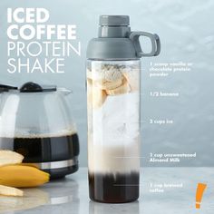 an iced coffee protein shaker next to bananas and other ingredients on a marble countertop