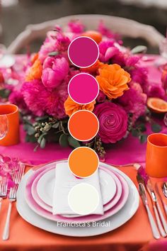 the table is set with pink and orange flowers