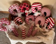 a basket filled with lots of red and white christmas decorations