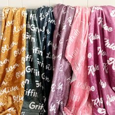 four different colored towels hanging up on a wall with the word griff printed on them