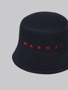 Bucket hat made from organic cotton gabardine. Embellished with embroidered Marni lettering on the front. Lined in cotton. Cotton Hat With Logo And Curved Brim, Cotton Hats With Logo Detail And Curved Brim, Cotton Hats With Logo And Curved Brim, Cotton Curved Brim Hat With Logo Detail, Black Wide Brim Hat With Embroidered Logo, Flat Brim Cotton Hat With Logo, Embroidered Logo Cotton Hats, Hat Making, Recycled Paper