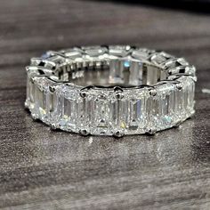 a diamond ring sitting on top of a wooden table