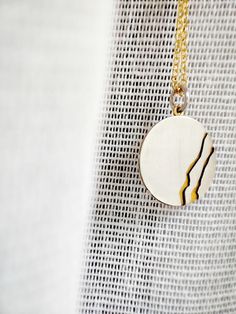 Embrace the timeless beauty of Kintsugi with our handmade small round pendant necklace. Inspired by the ancient Japanese art of mending broken ceramics with precious metals, this pendant combines delicate silver and gold elements in a dainty, minimalistic design. A perfect accessory for both men and women, it symbolizes the beauty found in imperfections and the art of embracing life's scars. You can discover the KINTSUGI COLLECTION here: https://www.etsy.com/shop/GlafxJewelry?ref=seller-platform Handmade Elegant Round Medallion Necklace, Elegant Handmade Round Medallion Necklace, Artisan Necklace With Coin Pendant, Artisan Necklace With Polished Round Pendant, Artisan Necklace With Round Pendant And Polished Finish, Minimalist Round Locket Jewelry, Artisan Polished Round Pendant Necklace, Handmade Yellow Gold Round Pendant Medallion Necklace, Artisan Round Pendant Necklace With Polished Finish