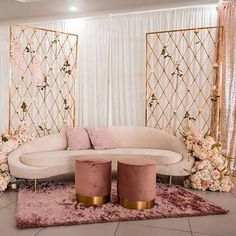 a white couch sitting on top of a pink rug