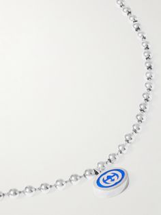 Perfect for illustrating where your brand loyalty lies, Gucci's necklace features a colourful enamel pendant detailed with an 'GG' logo. It's suspended from a silver ball-bead chain, which draws on military styles. Luxury Silver Jewelry With Logo, Designer Silver Jewelry With Logo, Luxury Sterling Silver Jewelry With Logo, Silver Necklace With Silver-tone Logo Plaque For Gift, White Gold Necklace With Silver-tone Logo Plaque, Luxury Gucci Silver Chain Jewelry, Gucci Silver Chain Jewelry As A Gift, Sterling Silver Pendant Necklace With Logo Charm, Sterling Silver White Gold Necklace With Logo Charm