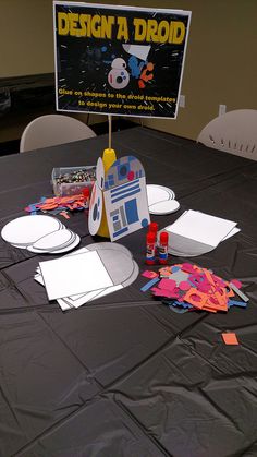 the table is set up with paper and crafting supplies to make star wars characters