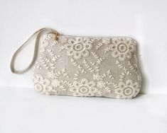 A lovely lace in floral embroidery covering a natural color linen, This zippered clutch is a perfect bridesmaid gift or bridesmaid clutch for garden theme or rustic wedding theme. The linen and lace clutch has a gold metal zipper accent and a hidden wrist strap so you can wear it as a wristlet when your hands are busy. The inside is roomy enough for small essential things like mobile phone, make up, etc.  Outer Material : Natural Linen, Lace Inner Material : Cream cotton Closure : Magnetic snap Rustic Bridesmaids, Lace Purse, Bridesmaid Clutch, Best Leather Wallet, Purse Boutique, Bridesmaid Clutches, Floral Clutches, Wedding Purse