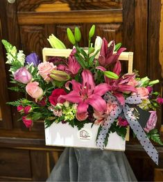 a bouquet of flowers in a white box