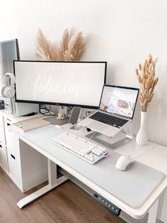 a computer desk with two monitors and a keyboard