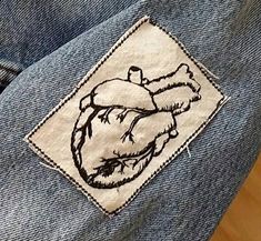 a patch on the back of a pair of jeans with an image of a human heart