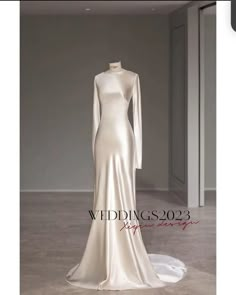 a white wedding dress on display in an empty room with the words weddings 2093