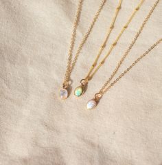 Our Dainty gemstone necklace features a tiny little stone, choose between opal, moonstone and turquoise.  DETAILS *PENDANT is Genuine Turquoise, Genuine Moonstone, or Synthetic Opal, measuring 5 x 7mm *CHAIN is 14k Gold Filled or Sterling Silver *CLASP is 14k Gold Filled or Sterling Silver Matching  PERSONALIZE IT!  ADD A STAR INITIAL CHARM: https://www.etsy.com/ca/listing/627638174/add-a-star-initial-charm ADD A STAMPED INITIAL: https://www.etsy.com/ca/listing/561708083/add-an-initial ADD A BIR Delicate Moonstone Necklace With Delicate Chain, Dainty Adjustable Opal Necklace, Dainty Opal Adjustable Necklace, Dainty Adjustable Moonstone Necklace, Dainty Moonstone Teardrop Pendant Necklace, Dainty Moonstone Charm Necklace For Gift, Dainty Oval Adjustable Necklace, Dainty Everyday Necklaces With Natural Stones, Delicate Moonstone Round Pendant Necklace