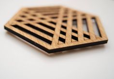 a close up of a wooden object on a white surface with no people around it