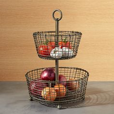 three tiered metal basket holding apples and cheese