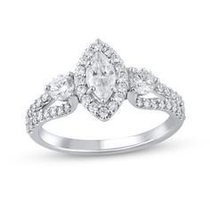 Start your love story with the exquisite sparkle of this marquise and round diamond three-stone engagement ring. Created in 14K white gold A diamond halo surrounds the 3/8 ct. marquise-cut diamond. Shimmering 1/5 ct. round diamonds flank the center. Diamonds line the looped ribbons of the split shank. This engagement ring dazzles with 1-3/8 cts. t.w. of diamonds. Three Stone Marquise Cut Diamond Jewelry, White Marquise Cut Three Stone Jewelry, Marquise Three Stone Wedding And Anniversary Ring, Silver Marquise Three-stone Jewelry, Fine Jewelry Marquise Three Stone, Fine Jewelry With Three Stone Marquise Cut, Marquise Three Stone Wedding Ring For Anniversary, Marquise 14k White Gold Ring With Center Stone, Marquise Cut Three Stone Diamond Ring For Anniversary