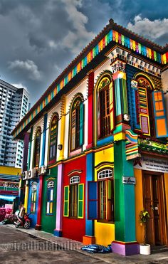 a multi - colored building in the middle of a city