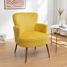 a yellow chair sitting on top of a hard wood floor