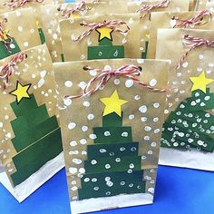 small brown bags decorated with christmas trees and stars