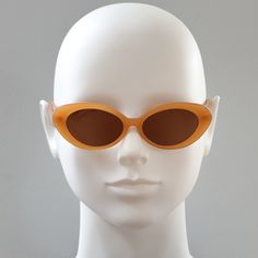 Round Cateye sunglasses.  Tan acetate frame with brown lenses.  Frame Specs: Lens Category 3 UV400 100% UV Protection Acetate Frame Lens Height: 32mm, Lens Width: 50mm, Sunglass Length (including frame): 143mm Brown Tinted Plastic Sunglasses, Brown Cat Eye Sunglasses With Uv Protection, Brown Cat-eye Sunglasses With Uv Protection, Brown Tinted Cat Eye Sunglasses For Parties, Brown Plastic Sunglasses With Uva Protection, Modern Orange Cat Eye Sunglasses With Mirrored Lenses, Brown Plastic Cat Eye Sunglasses, Brown Polarized Sunglasses For Party, Brown Polarized Sunglasses For Parties