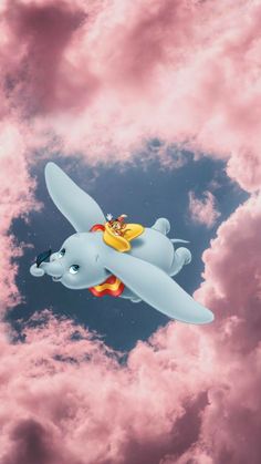 a cartoon character flying through the air on top of an airplane in the sky with clouds