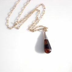 This lovely natural tortoise shell dimensional pendant almost certainly began its life as one of a pair of earrings. From the Victorian era, this teardrop shaped shell is highly polished and has a dark side and a side with more amber in it along with beautiful inclusions. I have tried to show this with the photos. The shell is topped with a 10k gold cap, tested with acid, could be a thick shell of gold over silver or brass but I think its solid. There is some patina on the top and minor surface Antique Teardrop Cabochon Jewelry, Vintage Brown Jewelry With Polished Finish, Elegant Brown Necklace With Polished Finish, Formal Brown Jewelry With Polished Finish, Vintage Teardrop Jewelry With Polished Finish, Unique Brown Teardrop Pendant Jewelry, Amber Teardrop Jewelry For Anniversary, Brown Dangle Jewelry For Formal Occasions, Brown Hallmarked Jewelry As Gift