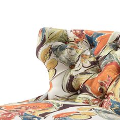 an upholstered chair with colorful fabric on it