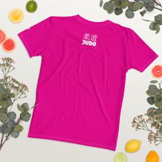 a pink t - shirt with the word jumbo written in chinese on it surrounded by citrus fruit