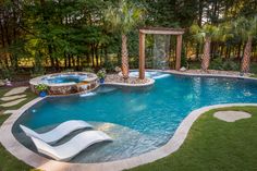 an outdoor pool surrounded by grass and trees