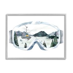 a pair of ski goggles with mountains in the background