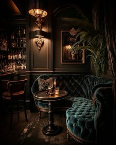 a dark room with green velvet couches and tables