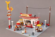 a lego model of a diner with people sitting outside