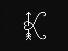 the letter k with an arrow drawn on it in white ink against a black background