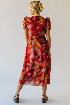 The Fannon Floral Midi Dress in Red Multi is sure to turn heads with its vibrant colors and playful floral pattern. With a comfortable and flattering midi length, this dress is perfect for any occasion. Bring a touch of whimsy to your wardrobe with this one-of-a-kind dress. Details self/lining: 100% polyester Fabric Care Guide Here Sizing & Fit Measurements are approximate and taken while laying flat across the front. Not doubled. small: bust = 18"; length = 48" medium: bust = 19"; length = 48.5 Vibrant V-neck Midi Dress With Vibrant Print, Orange A-line Midi Dress With Floral Print, Multicolor Printed V-neck Midi Dress, Red V-neck Midi Dress With Vibrant Print, V-neck Floral Print Rayon Midi Dress, Striped Sweater Dress, Puff Sleeve Sweater, Striped Knit Dress, Floral Midi Dress