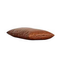 a brown leather pillow on a white background