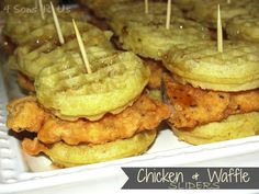 chicken and waffles are stacked on top of each other with toothpicks sticking out of them