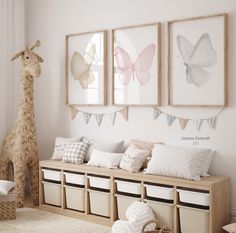 a room with some stuffed animals on the wall and pictures hanging above it, including a giraffe