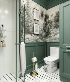 a bathroom with green painted walls and white tile flooring, along with a toilet