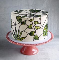 a white cake with green leaves on it