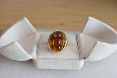 This is a signed Pomellato Mosaico model ring. This vintage ring is crafted in 18-carat gold and adorned with citrines. The citrines, skillfully cut to create a checkerboard pattern, inspired the name of this ring model. Please note that this model is no longer available for sale by the Pomellato house. Weight: 25.8 grams Size: 53 FR (6.5 US - N UK) Dimensions: 2.4 x 2.3 cm Metal: 18-carat gold Stones: Citrines Jeweler: Pomellato Pomellato Ring, Luxury Rings, Birthday Ring, Checkerboard Pattern, Vintage Signs, Ring Gift, Vintage Rings, Fashion Rings, Wedding Rings Engagement