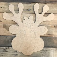 a wooden cutout of a reindeer with antlers on it's head and nose