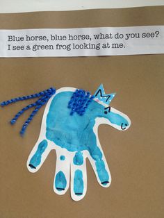 a blue horse painted on top of a piece of paper