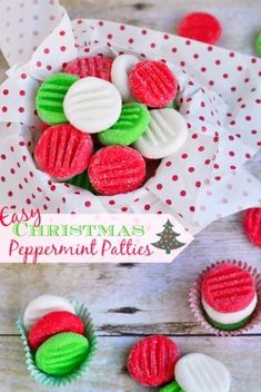 some red, green and white cookies are in a paper wrapper on a wooden table