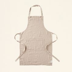 the apron is made from linen and has two straps on one side, while the other end