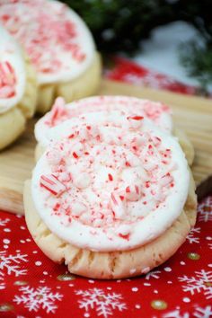 two cookies with white frosting and red sprinkles