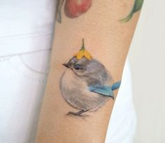 a bird with an apple on it's arm