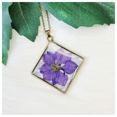 "Handmade violet purple pressed dried flower large geometric bezel resin pendant necklace. Chain Length: My pendant necklaces are made with a standard \"Princess\" length 18\" chain; I also offer custom length options. Choose your custom length by using the \"Necklace length\" drop-down menu located just above the add to cart button* (*length reference chart shown in pics) Colors: Violet Purple, Pearl White, Brushed Bronze Pendant Size: See Pics For Measurements & Size Scale Comparisons Materials: Pendant: Pressed Dried Flower, Resin, & Bronzetone Stainless Steel Chain: Bronzetone Stainless Steel (due to a variety of monitor/screen settings, IRL color may vary slightly, pics taken in natural light)" Purple Flower Shaped Necklace With Pressed Flowers, Purple Flower Jewelry With Pressed Flowers, Purple Flower Pendant Necklace For Birth Flower, Purple Flower Pendant Necklace With Birth Flower, Purple Birth Flower Pendant Necklace, Purple Soldered Pendant Jewelry, Soldered Purple Pendant Jewelry, Handmade Purple Rectangular Necklace, Personalized Purple Pendant Necklace