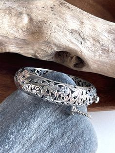 "Sterling Silver Silpada filigree bracelet bangle. This bracelet is aptly named \"Forever Stunning\". It has a classic style to it and can be worn with anything. It features an open-work filigree design, a hinged clasp and a safety chain. Fits wrists up to 7.5\" Additional Information: * Complimentary Gift Box! * All jewelry items come securely packaged and are mailed promptly upon payment - often same-day. * The majority of my vintage items are used and may show some wear. Please review all pho Classic Sterling Silver Bracelet With Filigree, Classic Silver Bangle With Intricate Design, Sterling Silver Bangle With Intricate Design For Anniversary, Ornate Engraved Sterling Silver Bracelet For Anniversary, Classic Sterling Silver Bangle With Intricate Design, Sterling Silver Cuff Bracelet With Intricate Design, White Gold Sterling Silver Bangle With Intricate Design, Ornate Sterling Silver Bangle Gift, Carved Sterling Silver Bangle