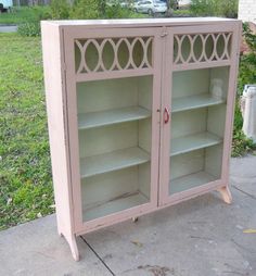 a pink cabinet sitting on top of a sidewalk