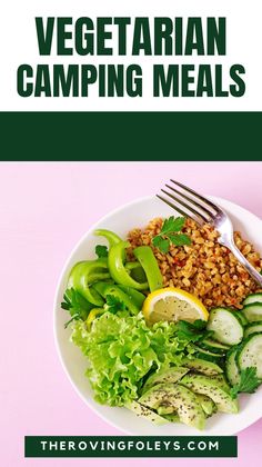 a white plate topped with vegetables and rice next to a fork on top of a pink table