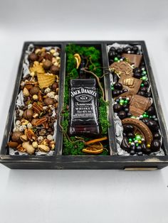 an assortment of liquor and nuts in a tray